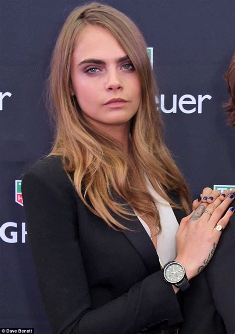 Cara Delevingne exposes her cleavage in a plunging leotard as 